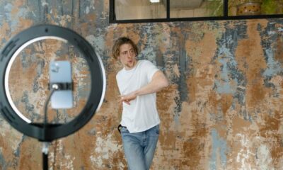 Social media influencer recording dynamic trending video content for TikTok and Instagram Reels using a ring light setup.