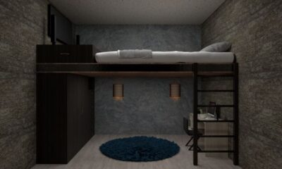 dark loft bed with desk and wardrobe below in teen bedroom