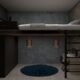 dark loft bed with desk and wardrobe below in teen bedroom